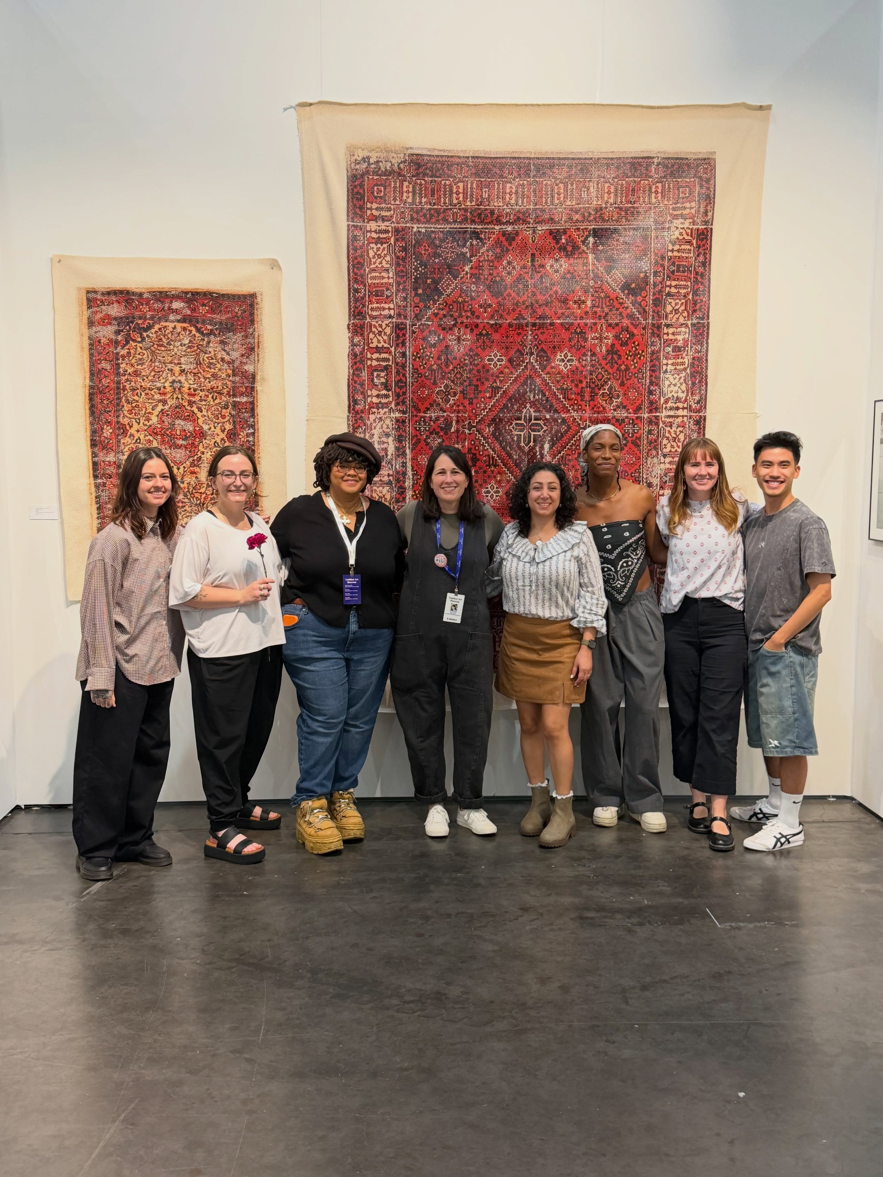 University of Houston MFA artists standing in front of rug-pattern artworks at Untitled Art, Houston 2026